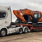 JCB cargo on the back of JJP Haulage Ltd Scania Lorry